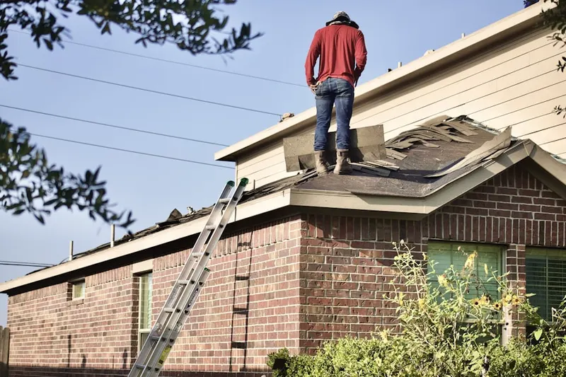 Professional roofer working on a residential roof in Grandwood Park
